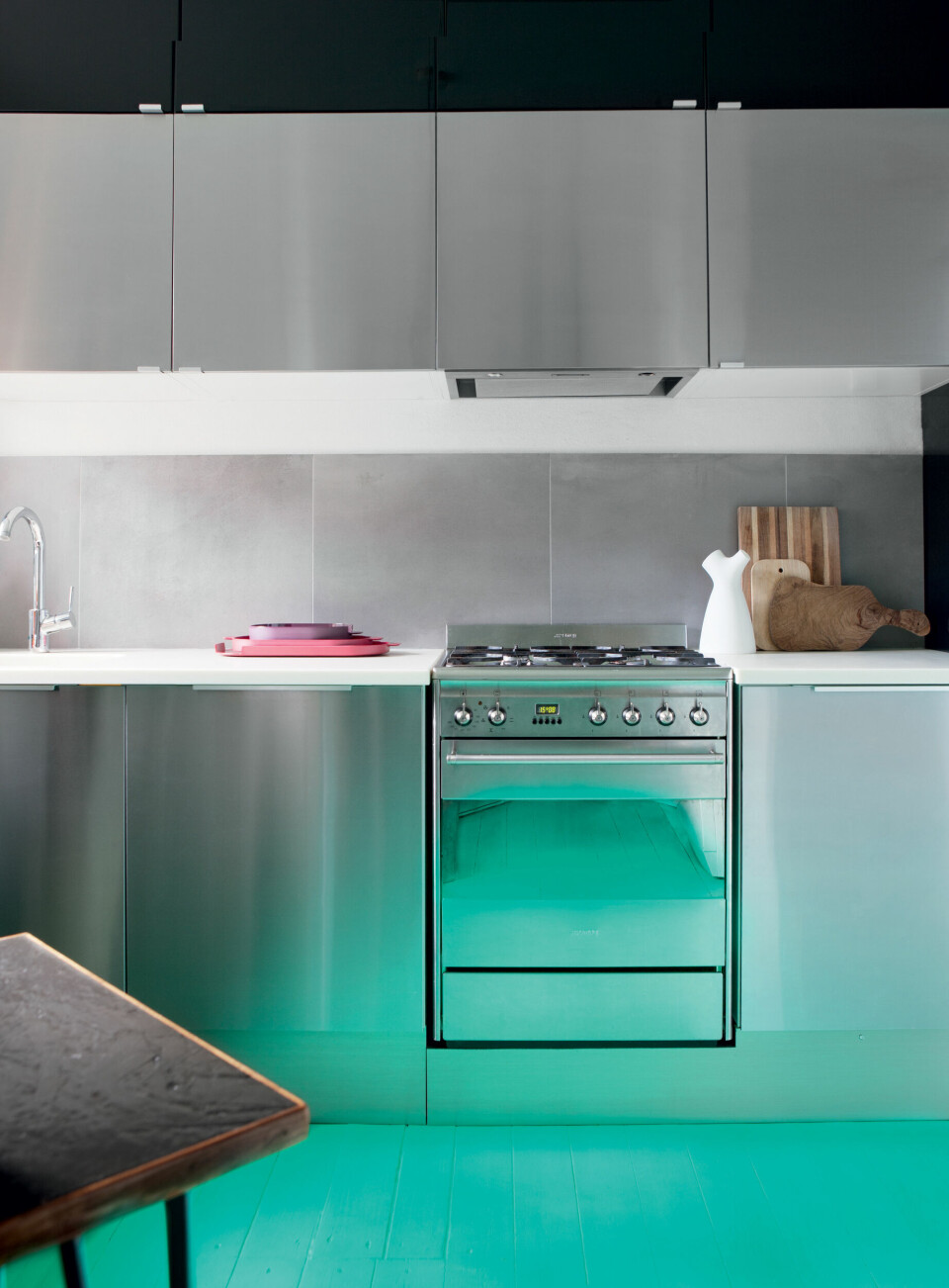 Køkkenmodulerne i rustfrit stål er fra Ikea, og bordpladen i corian fandt Pernille og Jens på Dba.dk, og skar den selv til, så den passede.
