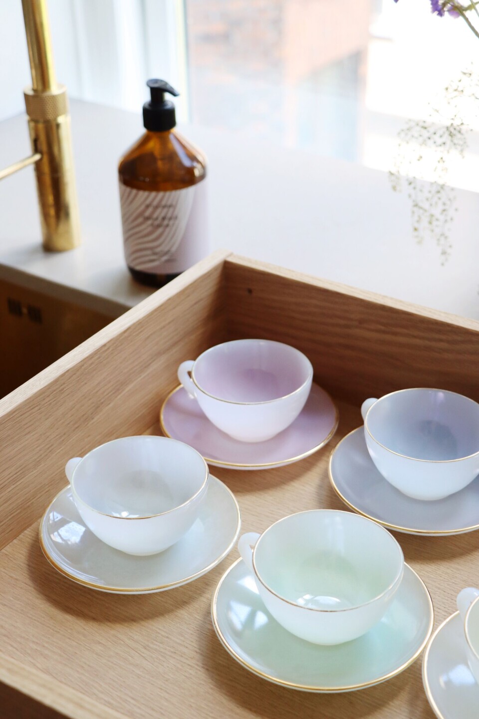 Køkkenskuffen er fyldt med pastelfarvede kopper.