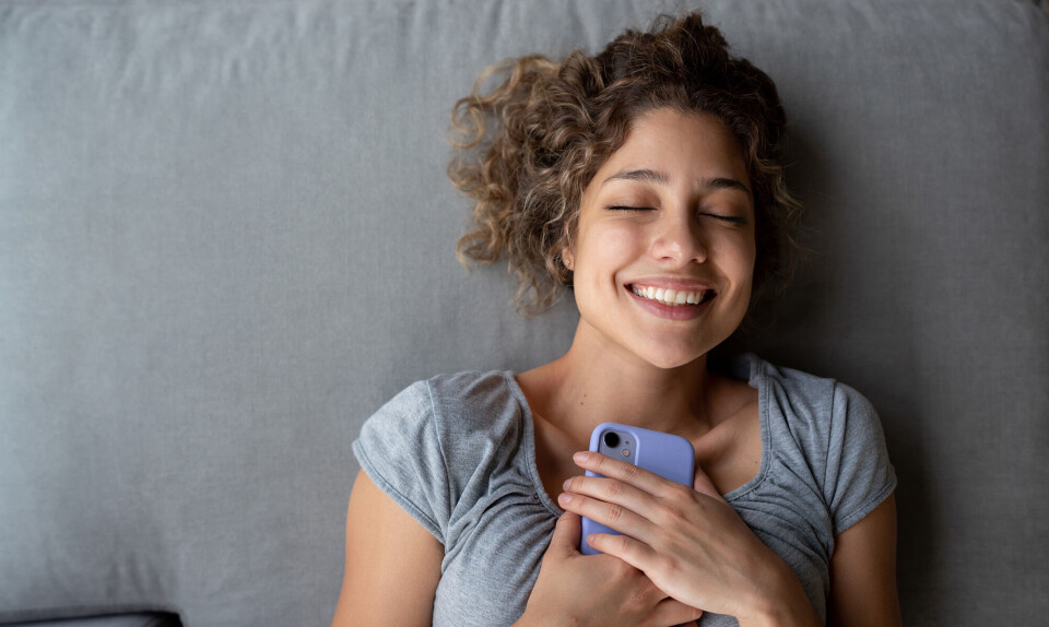 happy girl lying on bed smiling