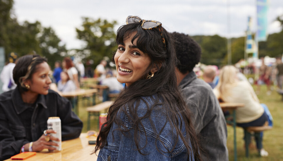 Woman sitting outdoors smiling.