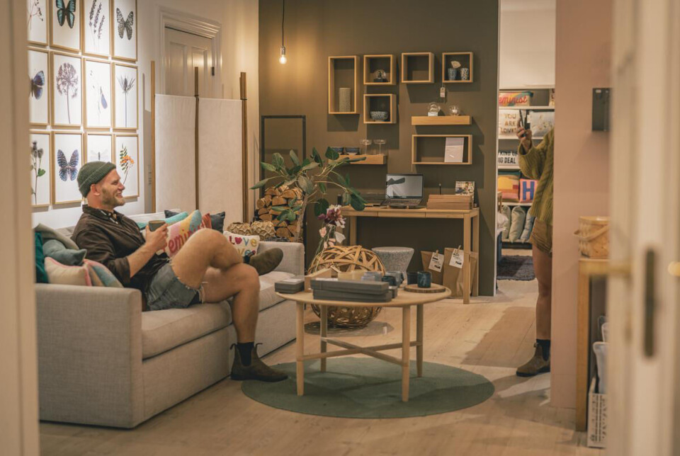 Mand sidder i sofa og drikker kaffe hos Veras Verden.