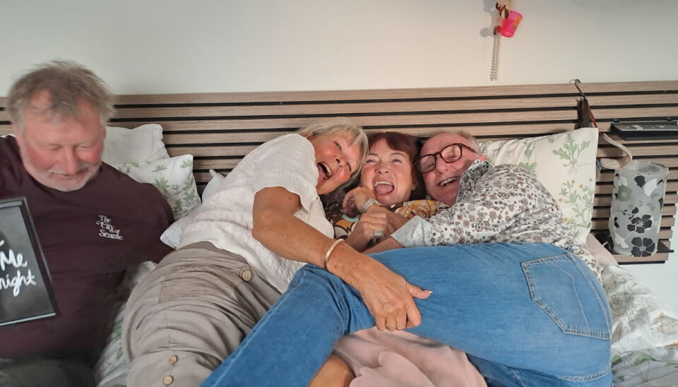 Bent, Lonnie, Jeanne og Jesper fra 'Hotel Romantik' ligger i en stor seng sammen og griner.
