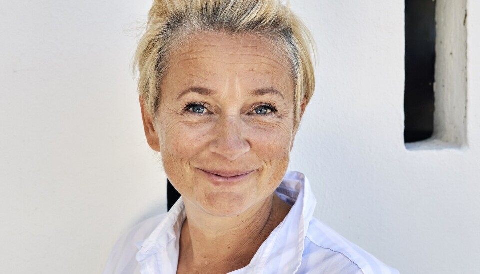Ane Cortzen smiler i en skjorte.