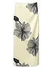 Lang cremefarvet nederdel med store sorte blomsterprint på hvid baggrund.