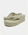 Beige flip-flop sandaler med høj kilehæl mod lys baggrund.