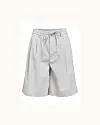 Lysgrå, løstsiddende bermudashorts med elastik og bindebånd i taljen mod lys baggrund.