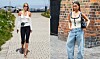 To kvinder i sommeroutfits går på brostensbelagte gader i byen.