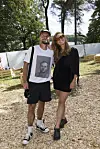 To festivalgæster står på træflis ved Smukfest 2026 omgivet af træer.