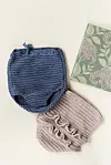 Hæklede babyshorts i blå og rosa ved siden af blomsterdekoreret notesbog