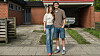 Josefine og Lasse står smilende foran et rødt murstenshus med carport.