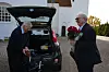 Janus Nielsen med røde roser ved en bil foran en hvid kirke